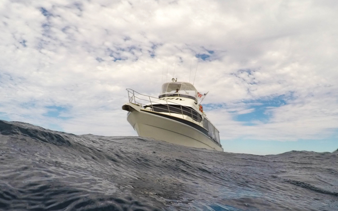 A white yacht at sea with a cloudy sky